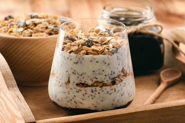 Natural yogurt with chia seed, muesli and jam.