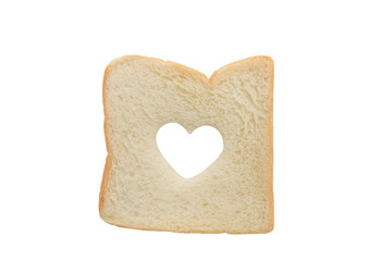 Heart shaped hole in a slice of bread isolated
