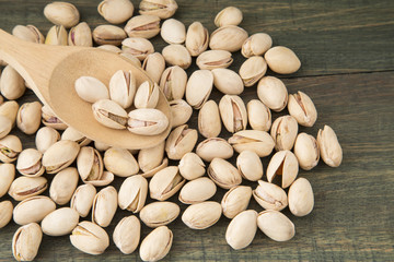 Pistachios in the wooden spoon (Pistacia vera)