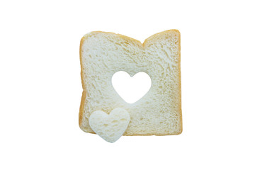 Heart shaped hole in a slice of bread isolated