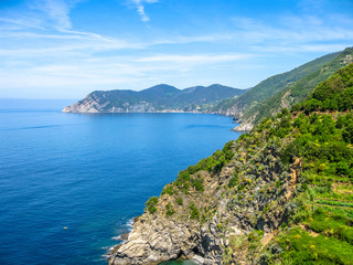 Fototapeta na wymiar Ligurian coast view from the popular trail between Vernazza and Monterosso al Mare. Landscape of Cinque Terre, National Park and Unesco Heritage, Italy.