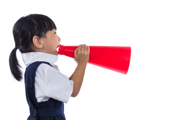 Asian Chinese little primary school girl holding retro megaphone