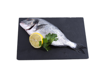 Fish, isolated twig with lemon and parsley