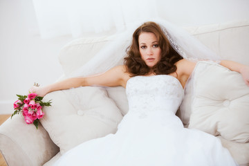 Bride: Annoyed Bride Sits On Couch with Bouquet