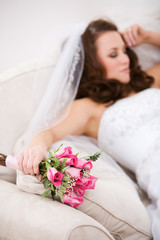 Bride: Tired Bride Rests On Couch With Bouquet