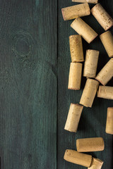Wine corks on dark wooden texture with copyspace