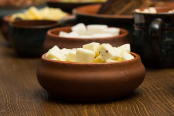 Italian cheese in an earthenware pot diced