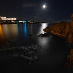 Night view of monaco bay rocks and the ocean
