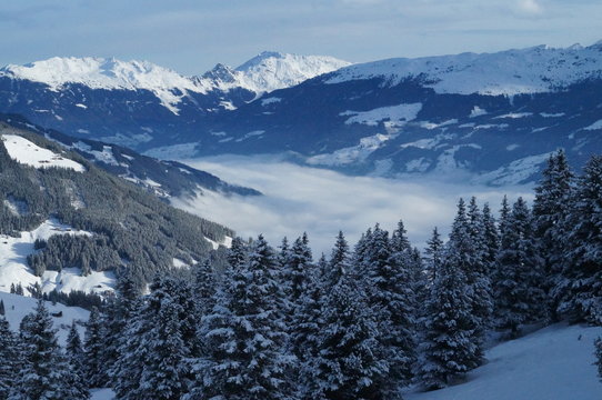 Snowy mountain view of the alps and a valley in the clouds © Markus