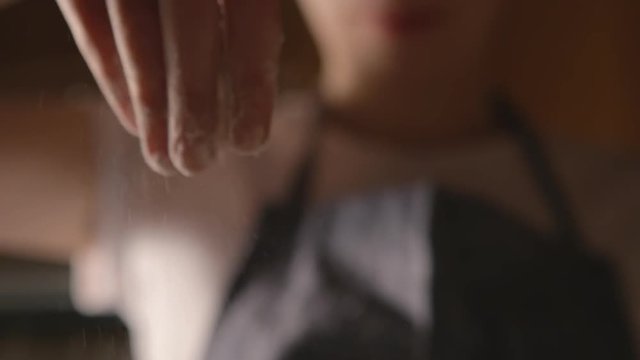 female hands floured dough close up