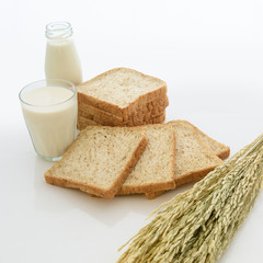 glass of milk and whole wheat bread