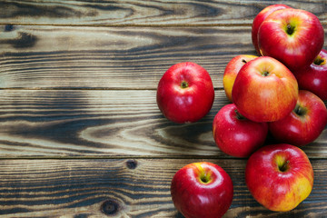 heap of red apples on a wooden background