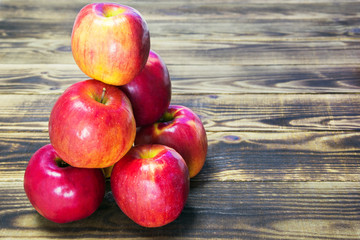pyramid of red apples on a wooden background - Powered by Adobe
