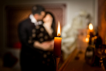 Young couple posing near piano in the dark