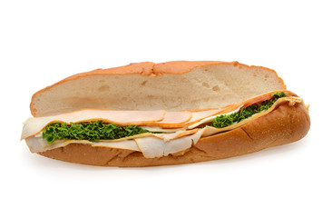 Turkey sub, long baguette sandwich with lettuce, slices of fresh vegetables, ham, turkey breast and cheese on white background