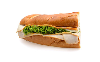 Turkey sub, long baguette sandwich with lettuce, slices of fresh vegetables, ham, turkey breast and cheese on white background