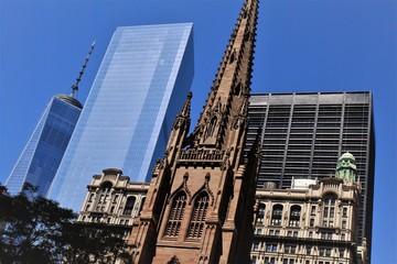 Naklejka premium New York City; Looking upwards on Broadway at Trinity Church