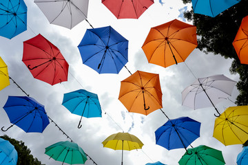 Creative decorative background from color umbrella above the str