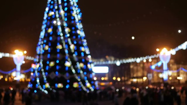 Blurred Background town square before the new year. Evening festivities urban residents around the Christmas tree