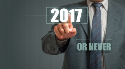 Business Man Touching An Imaginary Screen And Choosing 2017 Or Never