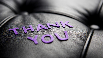 the word Thank You in black leather