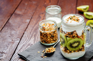 Obraz na płótnie Canvas Greek yogurt granola kiwi breakfast in jar