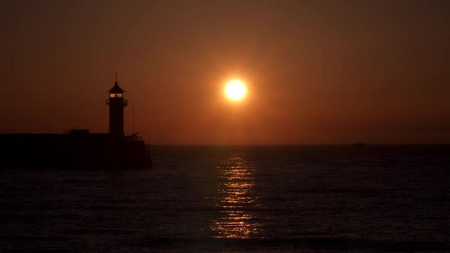 Reflection of the rising sun in the sea. Wieden lighthouse