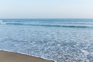 Blue ocean on sandy beach