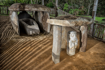 ancient pre-columbian tomb  in San Agustin Colombia with statue in ALtos de los Idolos, San Agustin, Colombia