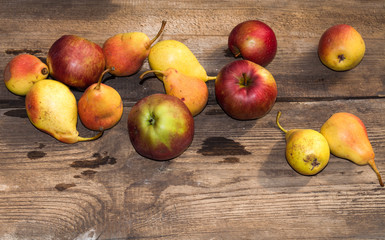 red apples and yellow pears on a wooden table, ripe apples and pears, food for sale, small business, agriculture,