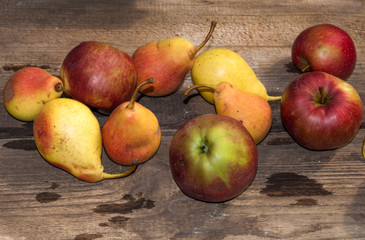 red apples and yellow pears on a wooden table, ripe apples and pears, food for sale, small business, agriculture,