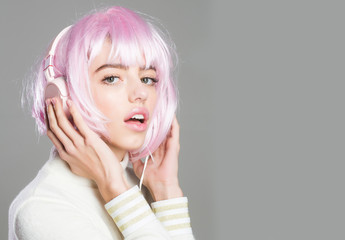 girl in pink wig with headset