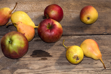 red apples and yellow pears on a wooden table, ripe apples and pears, food for sale, small business, agriculture,