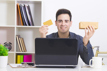 man with credit card and computer laptop with box purchases