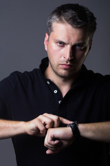 sexy handsome man with watch on hand
