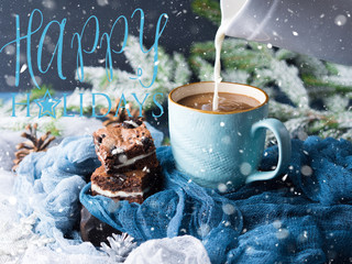 Cream cheese brownies with cookies on blue mug of coffee and milk being poured. Holiday background with fir tree branches and baubles falling snow. Christmas greeting card