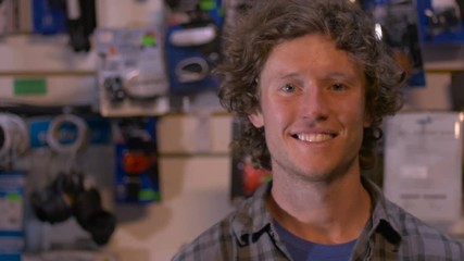 A freindly handsome blond millennial man standing in small business smiling