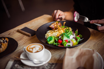 Breakfast table, man eating breakfast and drink coffee, close up