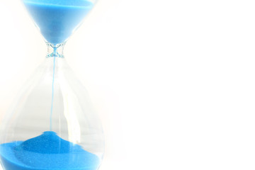 Hourglass with running blue sand suggesting passage of time