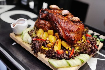 appetizing pork neck with potatoes and vegetables close-up