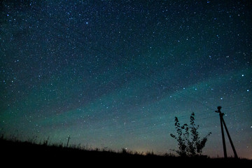 Naklejka na ściany i meble Starry night sky with aurora polaris over Belarus august 2016
