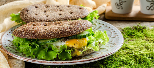 Healthy food - sandwiches of dark bread and poached eggs.