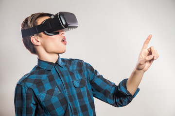 emotional funny man wearing virtual reality goggles. Studio portrait of video game designer wearing VR headset. studio shot isolated on gray background.