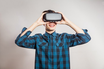 emotional funny man wearing virtual reality goggles. Studio portrait of video game designer wearing VR headset. studio shot isolated on gray background.