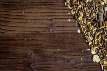 dry food for rodents on dark wooden background top view