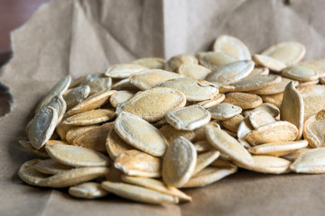 Grilled Pumpkin seeds with sea salt and spices on the wooden background