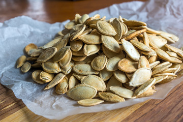 Grilled Pumpkin seeds with sea salt and spices on the wooden background