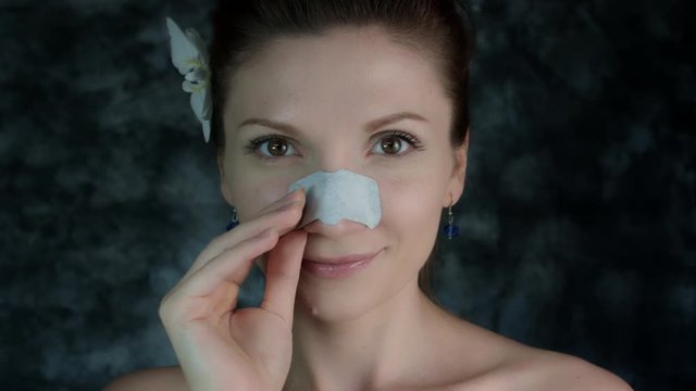4k Shot of a Woman Posing in Studio with Cleansing Plater on Nose