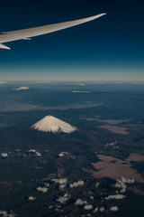 Mount Fuji volcano with a snow cap from Airplane window