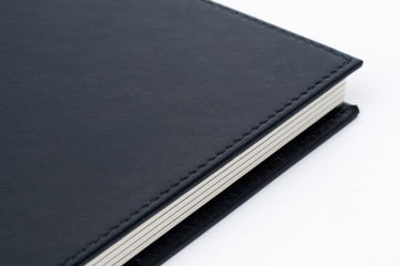 Black notebook on white background.